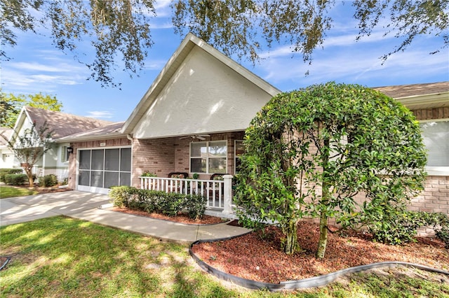 8981 SW 95th St Unit C, Ocala, FL 34481 - view of front of house with concrete driveway, a garage, covered porch, and brick siding
