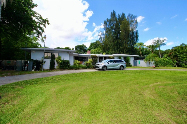 ranch-style home featuring a front yard