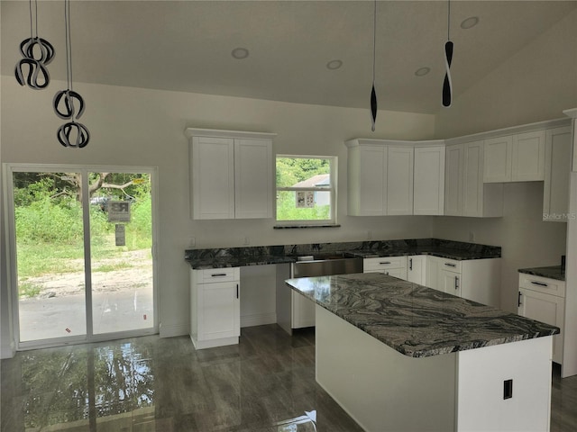 kitchen featuring white cabinetry, dark hardwood / wood-style floors, hanging light fixtures, and a kitchen island