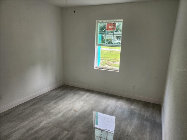 spare room with dark wood-type flooring