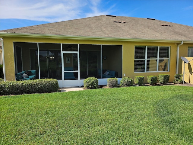 back of house with a sunroom and a yard