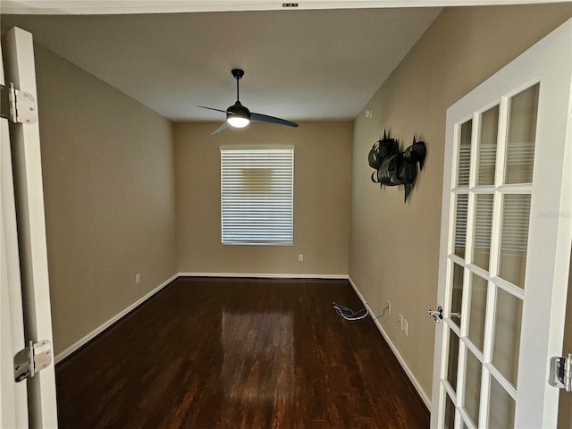 unfurnished room with ceiling fan and dark wood-type flooring