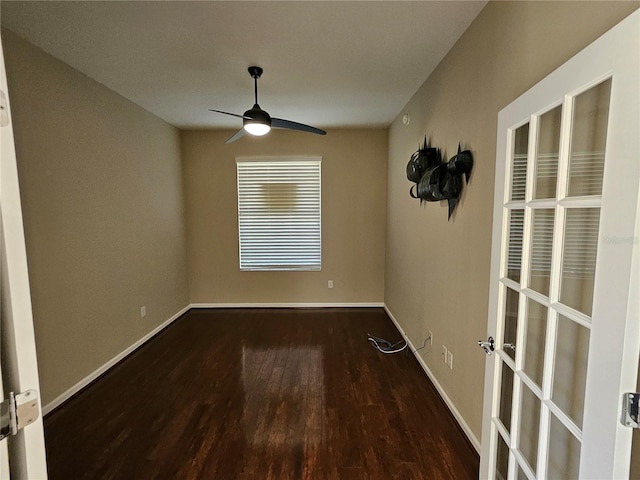 spare room with ceiling fan and dark hardwood / wood-style flooring