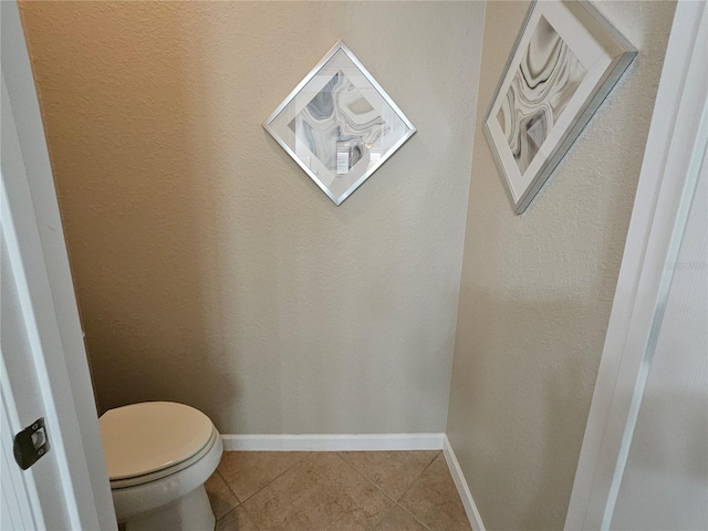 bathroom with tile patterned floors and toilet