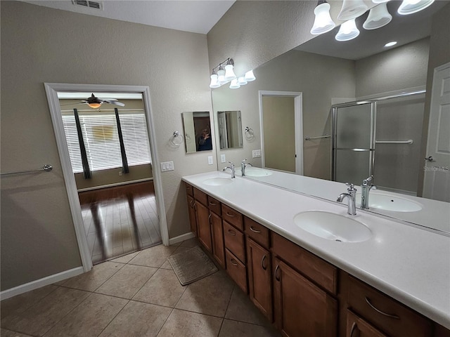 bathroom featuring ceiling fan, vanity, wood-type flooring, and a shower with shower door