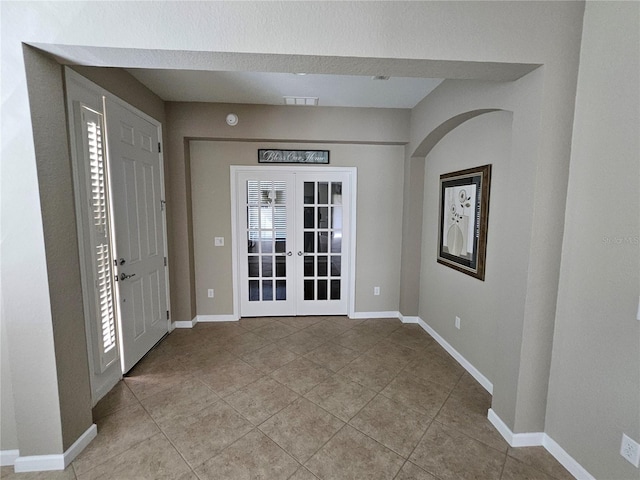 tiled foyer featuring french doors