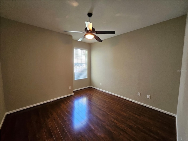 unfurnished room featuring dark hardwood / wood-style floors and ceiling fan