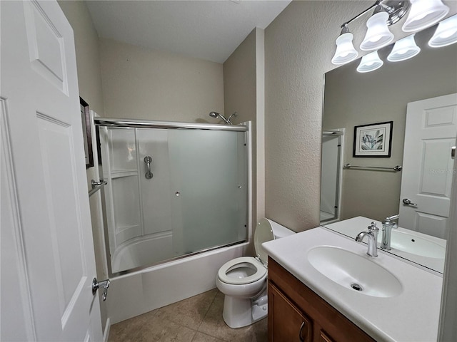 full bathroom featuring tile patterned flooring, vanity, enclosed tub / shower combo, and toilet