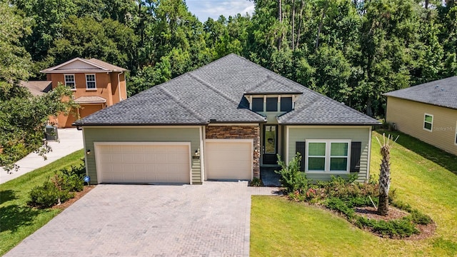 front facade featuring a front yard and a garage