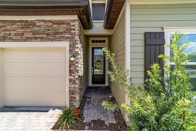 view of exterior entry with a garage