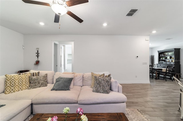 living room with ceiling fan and wood-type flooring