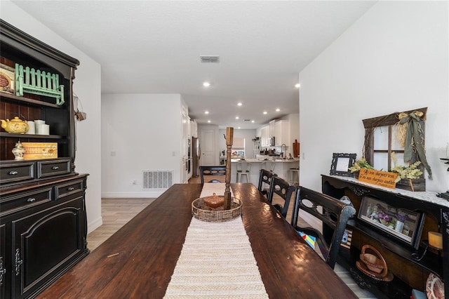 dining room with light wood-type flooring