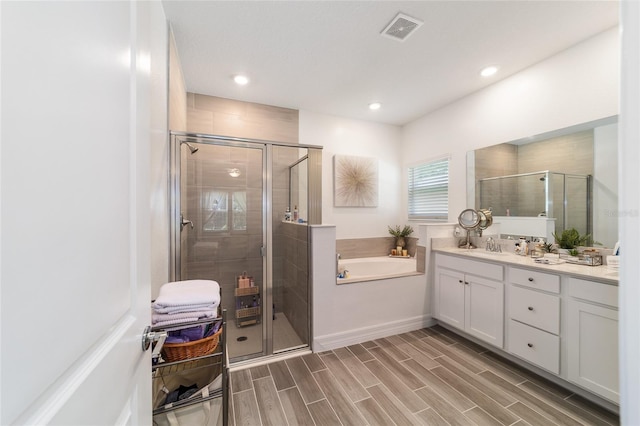 bathroom with independent shower and bath and vanity