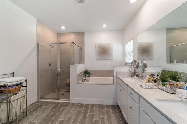 bathroom featuring vanity and separate shower and tub