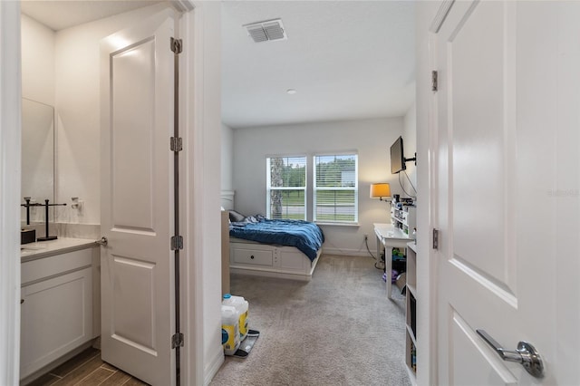 bedroom featuring light carpet