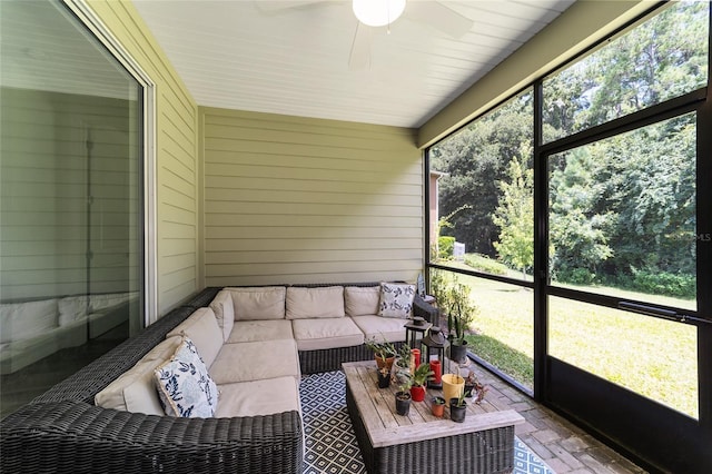 sunroom / solarium featuring ceiling fan