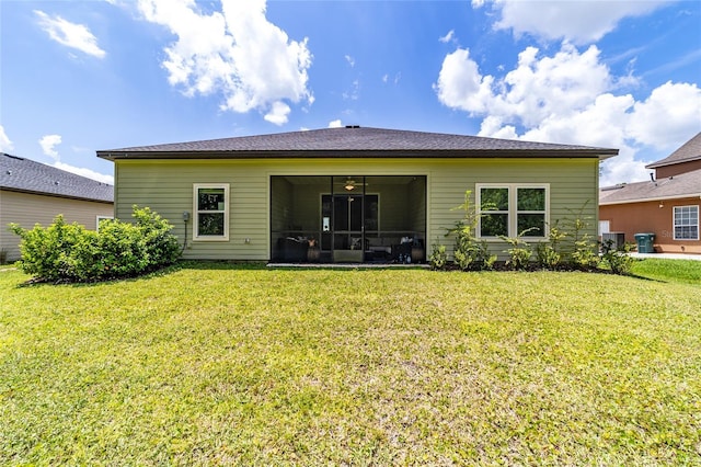 back of house featuring a yard, a sunroom, and central air condition unit