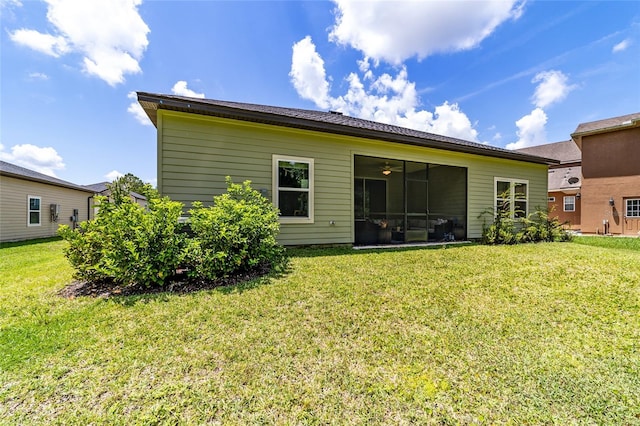 rear view of house featuring a yard