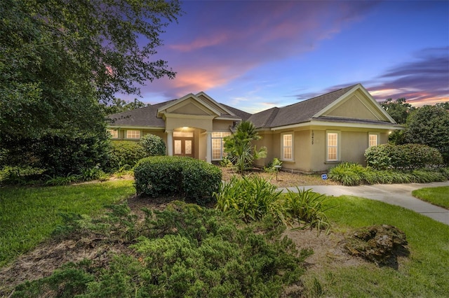 ranch-style house featuring stucco siding