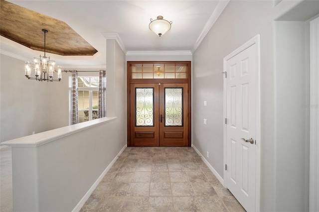 entrance foyer with crown molding and baseboards