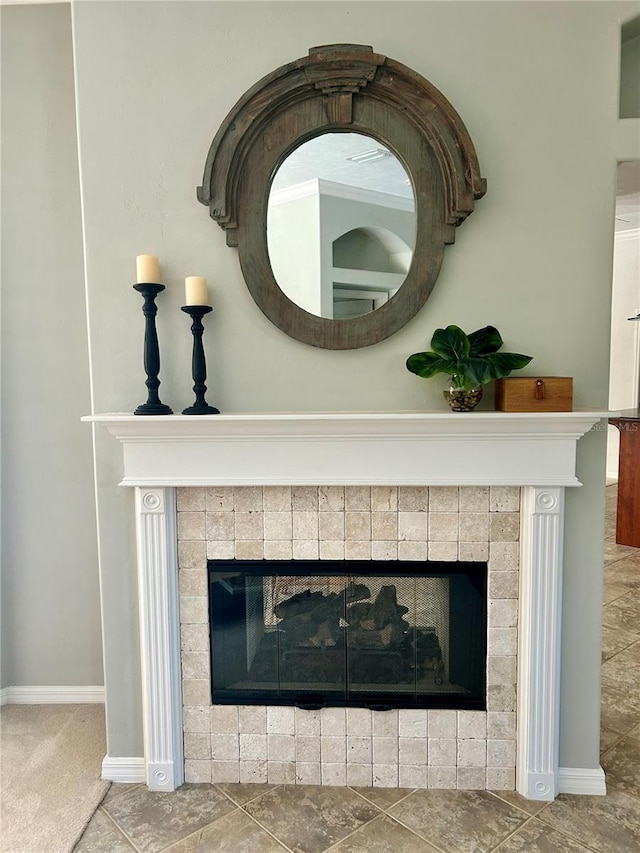 room details with a tile fireplace and baseboards