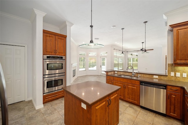 kitchen featuring stainless steel appliances, brown cabinetry, a peninsula, and decorative backsplash