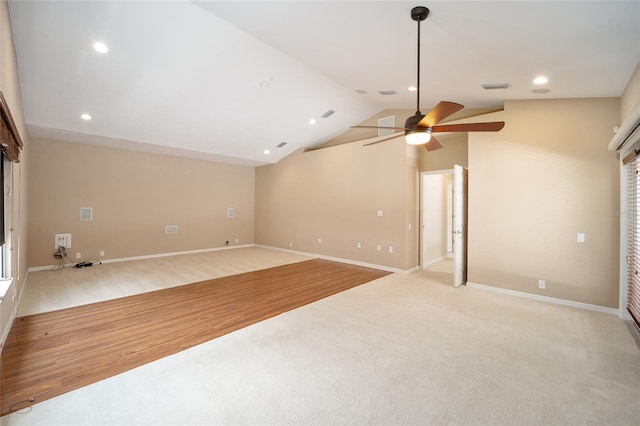 empty room with baseboards, visible vents, wood finished floors, vaulted ceiling, and recessed lighting