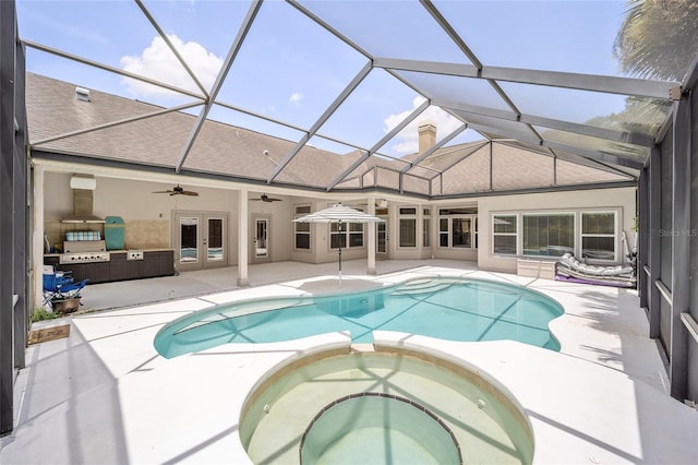 view of swimming pool with a patio, glass enclosure, a pool with connected hot tub, a ceiling fan, and french doors