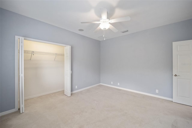 unfurnished bedroom featuring a closet, carpet, visible vents, and baseboards