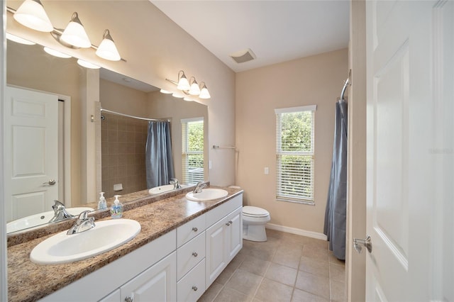 full bathroom with toilet, curtained shower, a sink, and tile patterned floors