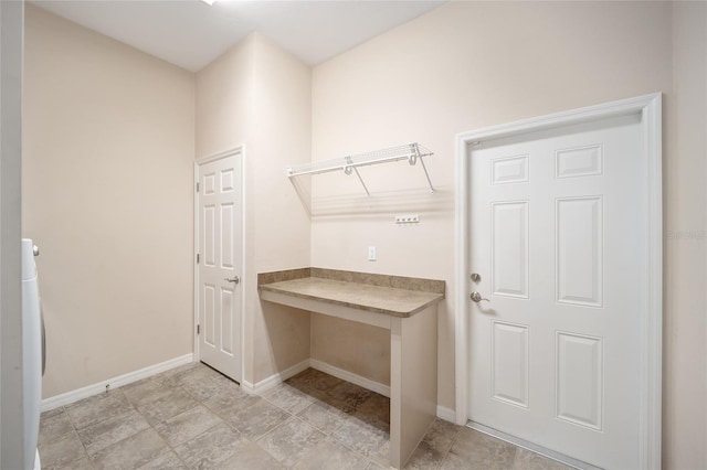 washroom featuring baseboards