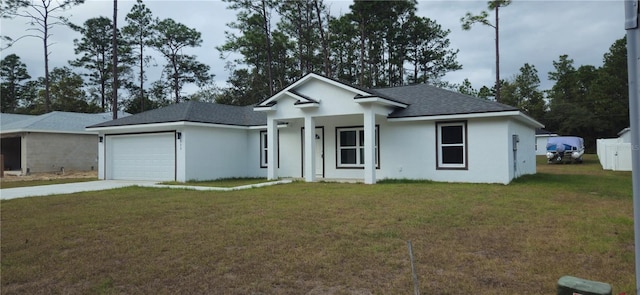 view of front of home with a garage and a front lawn