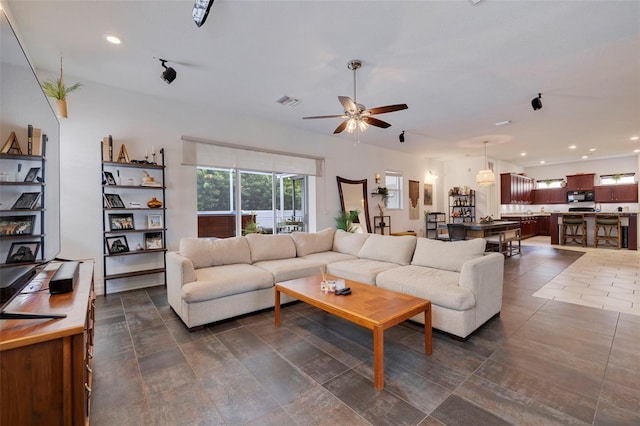 living room featuring ceiling fan and rail lighting