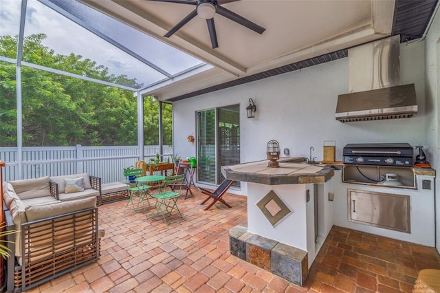 view of patio / terrace with outdoor lounge area, ceiling fan, glass enclosure, an outdoor kitchen, and grilling area