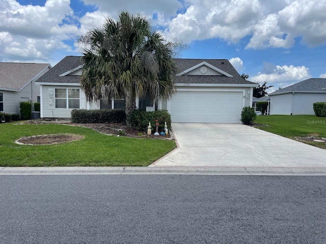 view of front of home with a garage and a front lawn