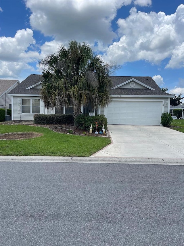 view of front of property featuring a garage and a front yard