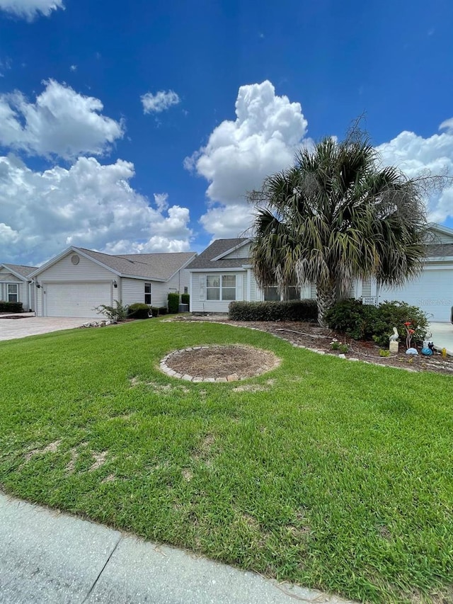 view of front of property featuring a garage and a front lawn