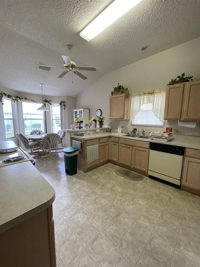 kitchen with light tile patterned flooring, ceiling fan, white dishwasher, lofted ceiling, and kitchen peninsula