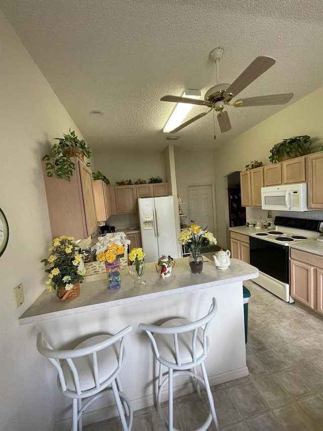 kitchen featuring light tile patterned floors, ceiling fan, light brown cabinets, and white appliances