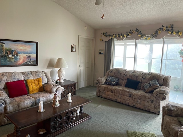 living room featuring a textured ceiling, ceiling fan, lofted ceiling, and carpet flooring