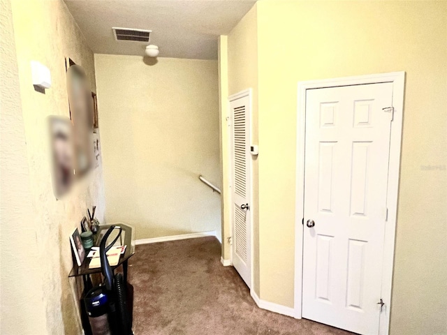 hallway with carpet flooring