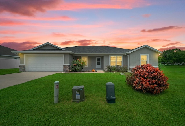 ranch-style house featuring a garage and a yard