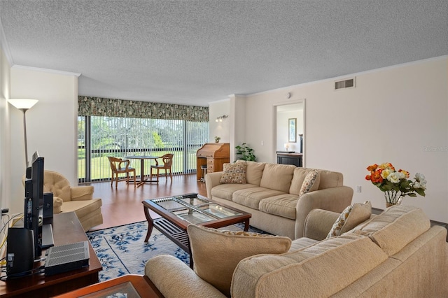 living room with crown molding, hardwood / wood-style floors, and a textured ceiling