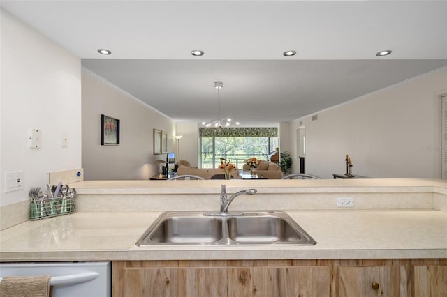 kitchen with dishwasher, ornamental molding, sink, and an inviting chandelier