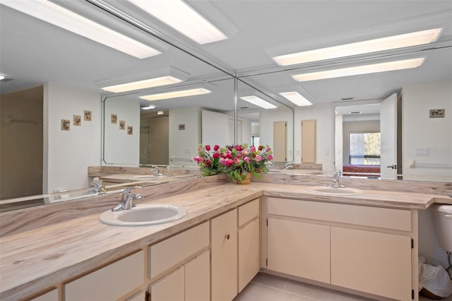 bathroom with dual vanity and tile patterned floors