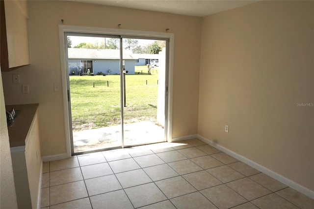 entryway featuring light tile patterned floors and baseboards