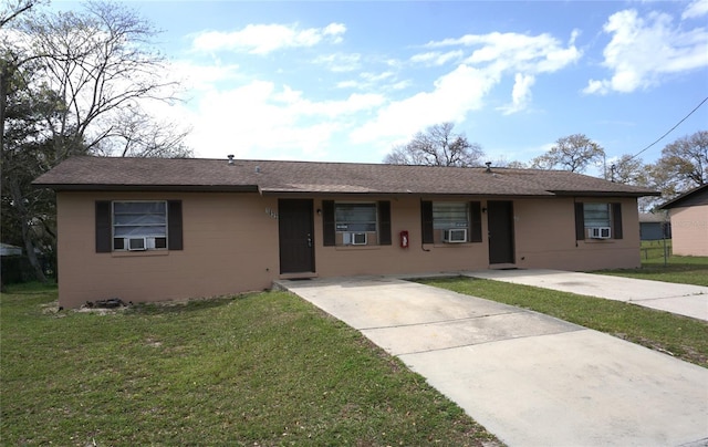 ranch-style house with a front yard, covered porch, and cooling unit