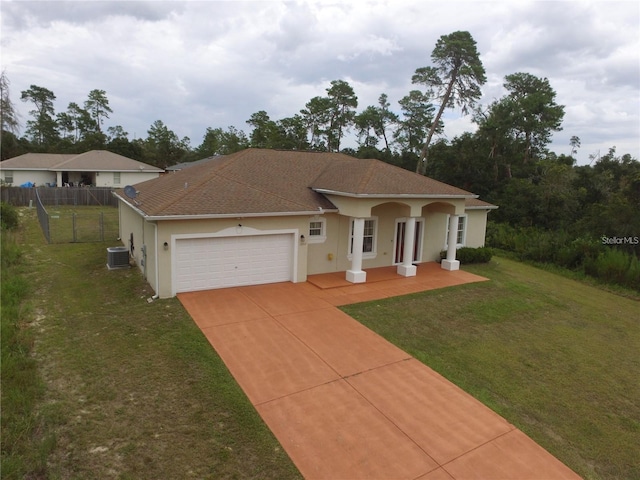 mediterranean / spanish house with a front lawn, a garage, a porch, and cooling unit