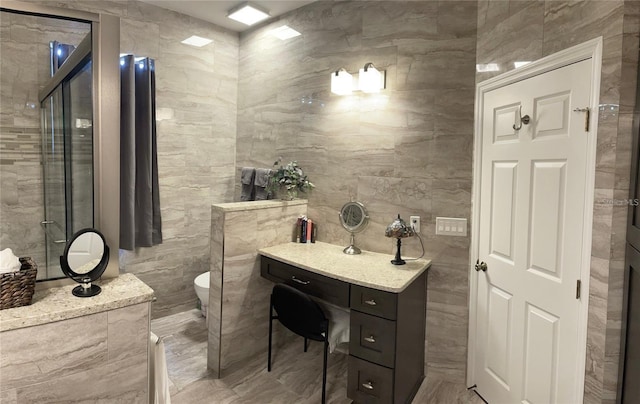 bathroom with toilet and tile walls