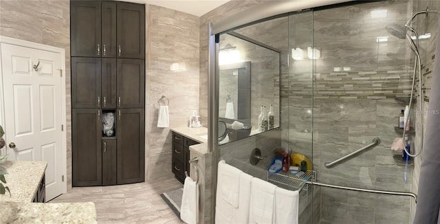 bathroom featuring vanity, tile walls, and walk in shower